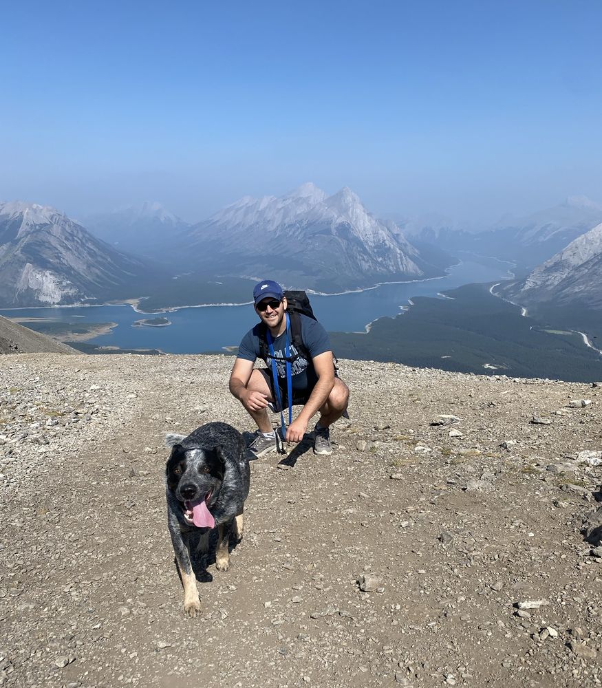 Edward of Southwest Pack & Paw with a dog on a mountain ridge in the Rockies